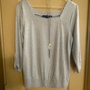 Blue blouse with necklace.